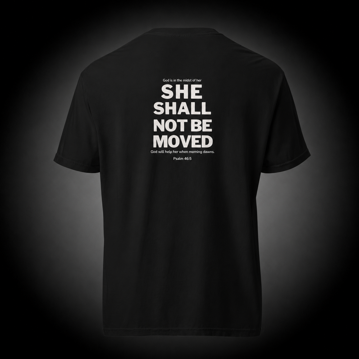 Unshaken Christian T-Shirt featuring Psalm 46:5 Bible verse "She Shall Not Be Moved" design on a premium black cotton tee
