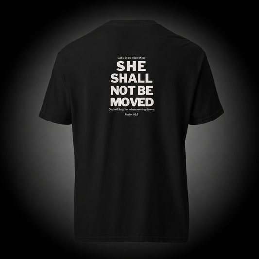 Unshaken Christian T-Shirt featuring Psalm 46:5 Bible verse "She Shall Not Be Moved" design on a premium black cotton tee