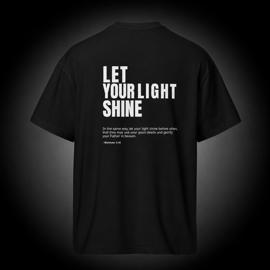 Unashamed Christian T-Shirt featuring Matthew 5:16 Bible verse "Let Your Light Shine" design on a premium black cotton tee